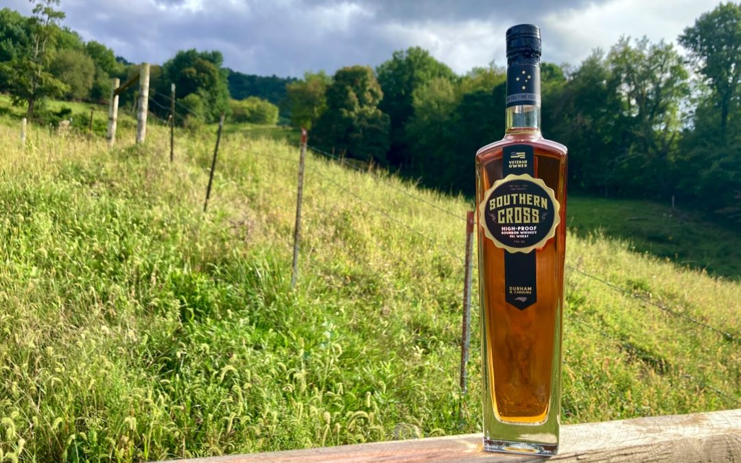 Swift Silent Deadly bottle of Southern Cross Bourbon sitting next to a field.